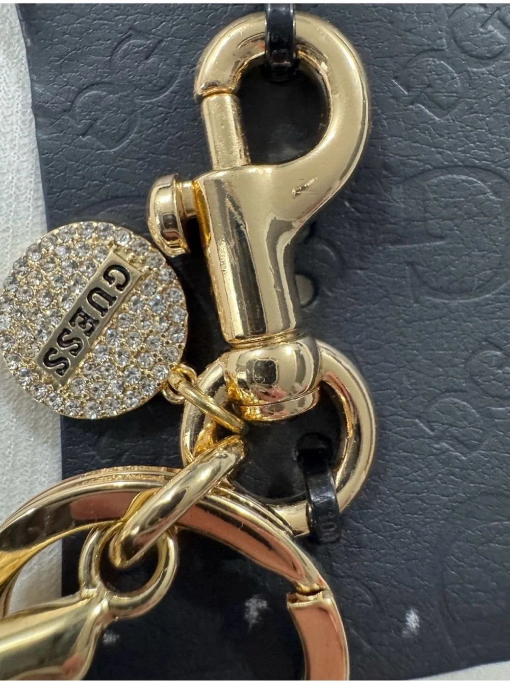 GUESS Black Glitter Cherry Bag Charm with Rhinestone Logo Disc in Gold Tone
